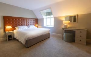 a bedroom with a large bed and a window at Heacham Manor Hotel in Hunstanton