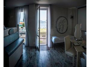 a living room with a view of a balcony at Hotel Butterfly in Torre del Lago Puccini