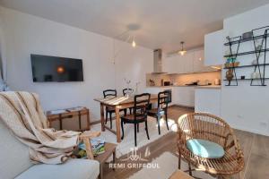 a kitchen and dining room with a table and chairs at La Symphonie Elevator Honfleur City Center 2 Guests in Honfleur