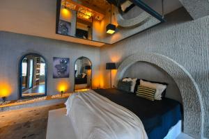 a bedroom with a large bed with an arched headboard at Villa Lada Slav in Kızılcakaya +46 photos