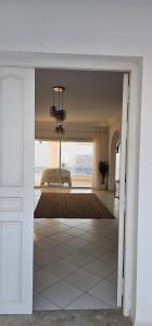 a hallway with a view of a living room with a chandelier at Villa Narjess in Taguermess