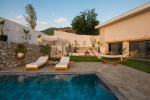 a backyard with a swimming pool and a house at Villa Lada Slav in Kızılcakaya