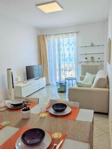 リッチョーネにあるAppartamento Vista sul Mare, Riccioneのリビングルーム(テーブル、皿付)