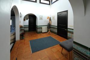 a hallway with two black doors and a blue rug at Isla Bonita Rental Home Moraira in Moraira