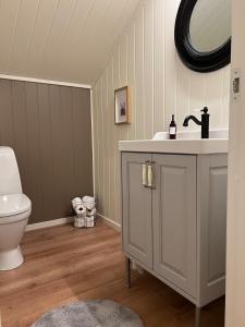a bathroom with a sink and a toilet at Bella Karnes in Oksevik +61 photos