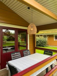 a porch with a table and chairs on it at Hip Huisje van Hout in Gramsbergen