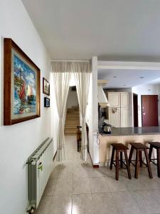 a kitchen and dining room with a table and chairs at Appartamento tra il borgo e il lago in Anguillara Sabazia +25 photos