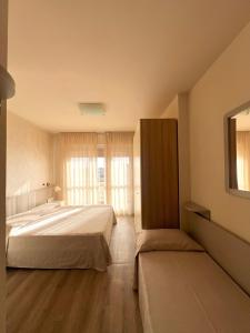Postel nebo postele na pokoji v ubytování Hotel Nuova Sabrina