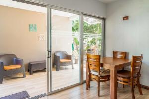 a dining room with a table and chairs at Casa Lapas in Uvita