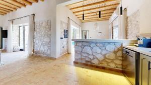 a kitchen with a stone wall and a counter at La Pausa du Douar in Essaouira