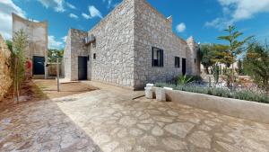 an exterior view of a stone house at La Pausa du Douar in Essaouira