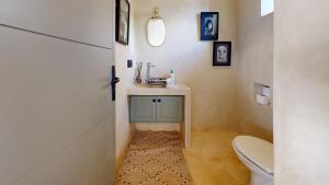 a small bathroom with a toilet and a sink at La Pausa du Douar in Essaouira +26 photos