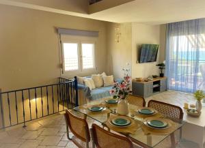 a living room with a glass table and chairs at Only Blue Villa in Karianí