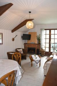 a living room with a couch and a fireplace at Douceur et quiétude rurale in Lassay-sur-Croisne
