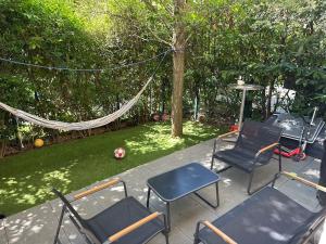 a patio with chairs and a hammock in a yard at Disneyland 10 minutes Paris 35 minutes in Bussy-Saint-Georges