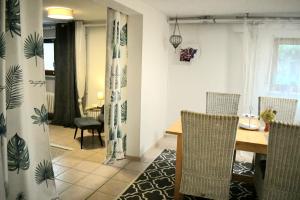 a kitchen and dining room with a table and chairs at Apartment Souterrain Bühl Vimbuch Familie Bork in Bühl