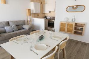 a living room with a white table and chairs at Villa 10 Marias in Cala Blanca