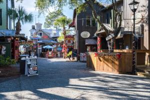 a street in a town with a sign on the sidewalk at Sandestin Golf and Beach Resort in Destin