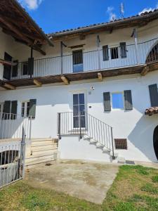 a large white building with stairs and balconies at Casa Mondonio in Castelnuovo Don Bosco