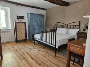 a bedroom with a bed and a wooden floor at Casa Mondonio in Castelnuovo Don Bosco