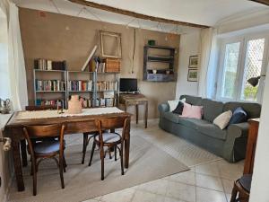a living room with a table and a couch at Casa Mondonio in Castelnuovo Don Bosco