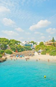 a group of people on a beach in the water at MarSenses Ferrera Blanca Hotel - Adults Only in Cala d´Or