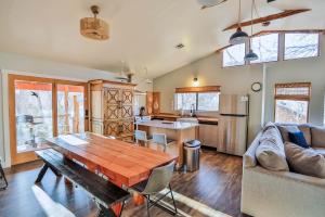 a kitchen and living room with a wooden table at The Blue Jay at Zen Zion in Glendale