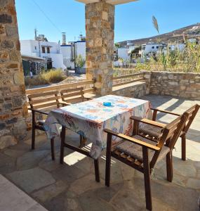 a table and two chairs sitting on a patio at Villa Dolphin in Azolimnos Syros
