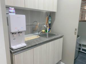 a kitchen counter with a sink and a microwave at Youth City Residence, Nilai in Nilai +4 photos