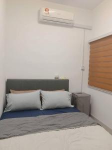 a bedroom with a bed with a air conditioner at Youth City Residence, Nilai in Nilai