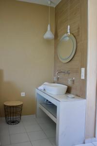 a bathroom with a sink and a mirror on the wall at Kekatos Studios in Lassi +29 photos