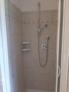 a shower with a shower head in a bathroom at Villa Finetti in Gubbio +16 photos