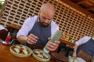 a man looking at his cell phone in front of a table at Port Alicante City & Beach in Alicante