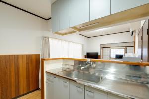a kitchen with a sink and a counter top at Sakura in Matsumoto