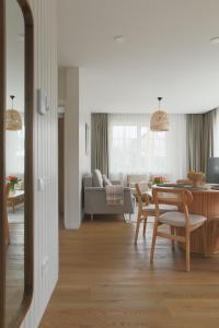 a living room with a table and a couch at Vila 44 in Druskininkai