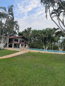 a resort with a swimming pool and palm trees at Finca Luciana in Jamundí