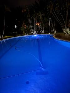 a large blue swimming pool at night at Finca Luciana in Jamundí