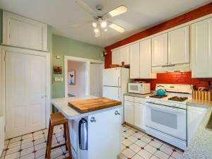 a kitchen with white appliances and a ceiling fan at Cozy Home in Historic Harrisburg in Harrisburg