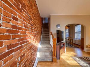 a brick wall with a staircase in a house at Cozy Home in Historic Harrisburg in Harrisburg +20 photos
