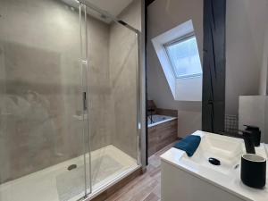 a bathroom with a glass shower and a sink at B'm Gretel - Duplex 4 pers - Vue Cathédrale - Centre Historique in Colmar