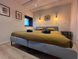 a bedroom with a large bed with two blue towels on it at B'm Hans - Centre Historique - Vue Cathédrale - 2P in Colmar