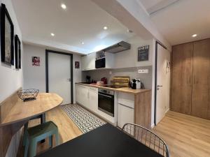 a small kitchen with a table and a counter top at B'm Hans - Centre Historique - Vue Cathédrale - 2P in Colmar