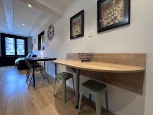a kitchen with a table and stools in a room at B'm Hans - Centre Historique - Vue Cathédrale - 2P in Colmar +12 photos