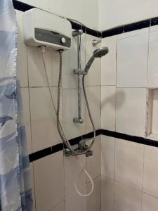 a shower in a bathroom with a shower head at Van Der Salle in Accra +21 photos