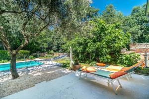 a hammock sitting next to a swimming pool at Casa Peronospora by Kompas Villas in Čepljani