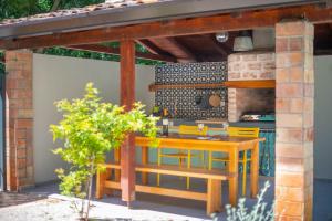 a patio with a table and chairs under a pergola at Casa Peronospora by Kompas Villas in Čepljani