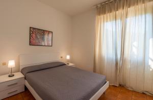 Posteľ alebo postele v izbe v ubytovaní Caletta Apartments