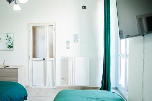 a bedroom with a bed and a large window at Angel Oak Palese Airport in Bari