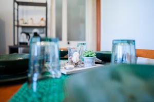 a table with glasses and a plate with a plant on it at Angel Oak Palese Airport in Bari +40 photos
