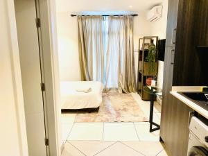 a small room with a bed and a window at KS Unique Studio Apartment in Accra